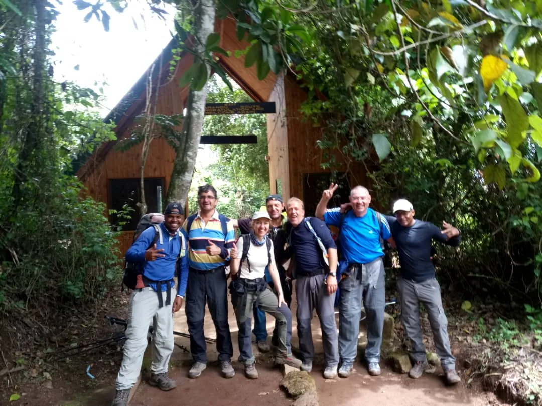 A happy Kilimanjaro group at the forest gate